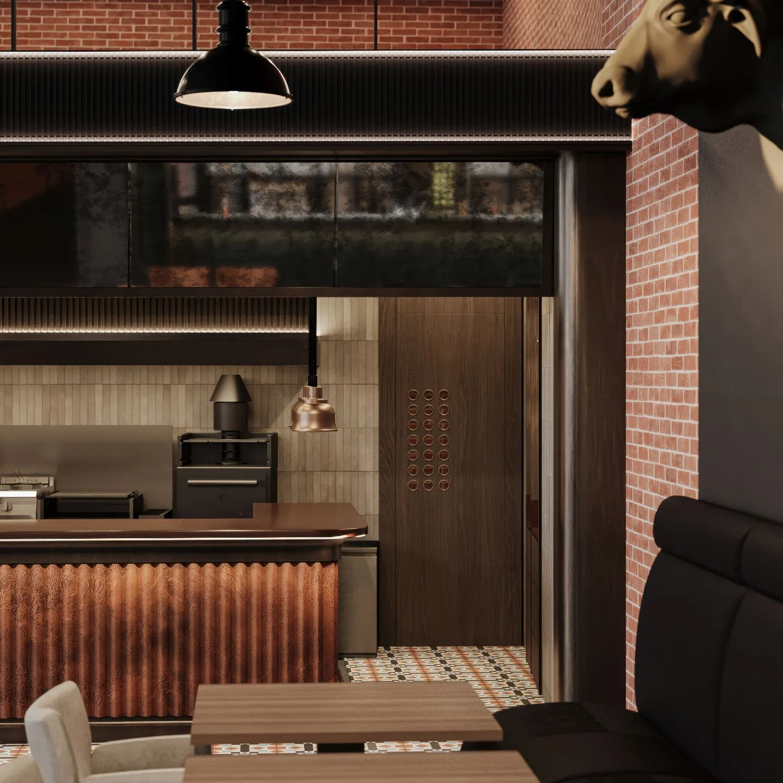 Double-height brick dining hall of a steakhouse in Erbil, with a fluted copper open-kitchen counter, black industrial pendants and a mezzanine above