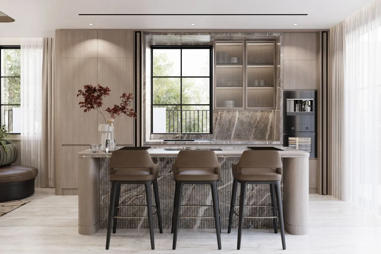 Show kitchen with a fluted marble island, three tan leather stools, reeded glass upper cabinets and integrated black appliances