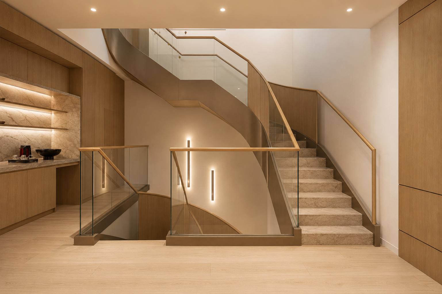 Curved stair in stone with bronze stringer, oak handrail and glass balustrade