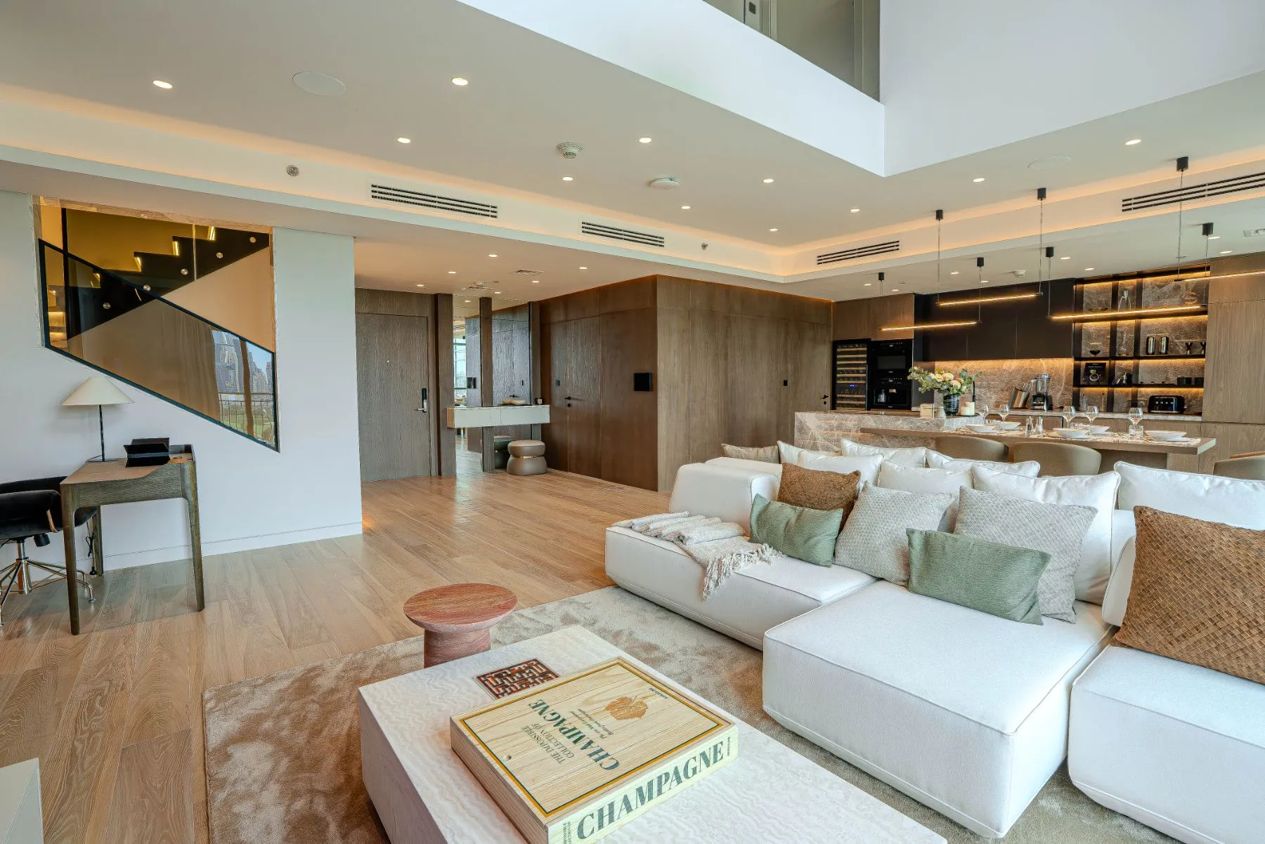 Open-plan living, dining and kitchen under a double-height volume