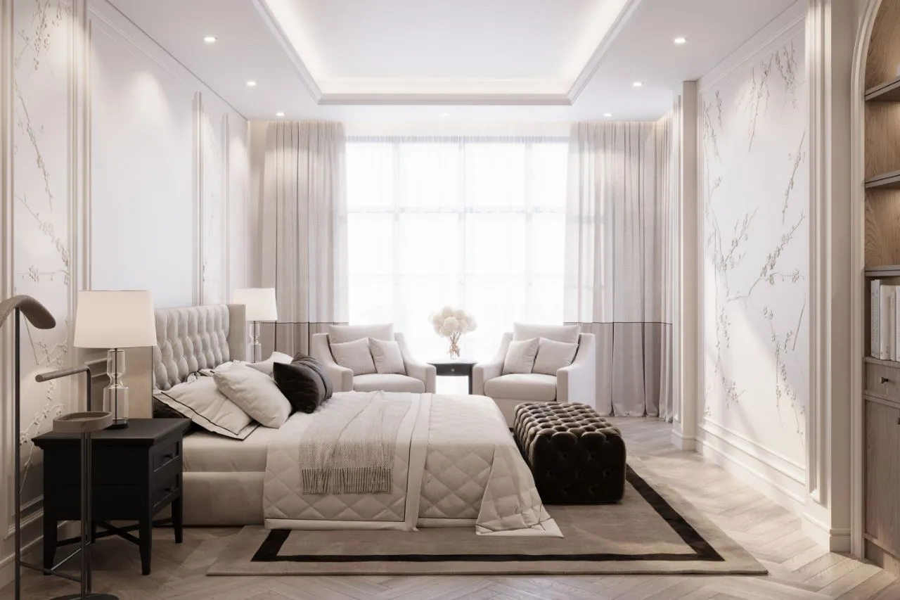 Principal bedroom with painted blossom wall panels, buttoned headboard, twin armchairs at the window and a chocolate velvet bench