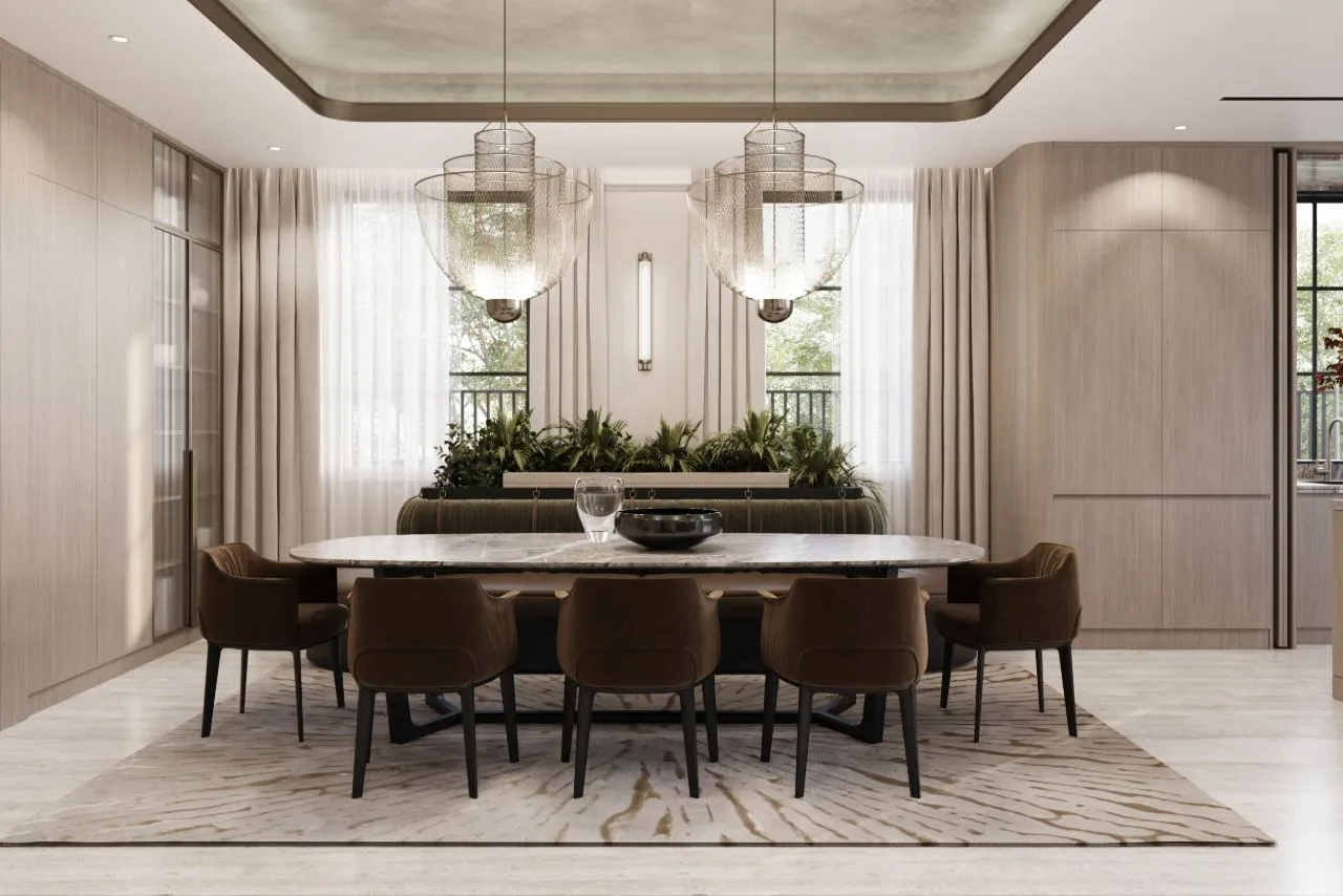 Dining room with an oval marble table, brown leather chairs, olive banquette and two woven mesh pendant lights