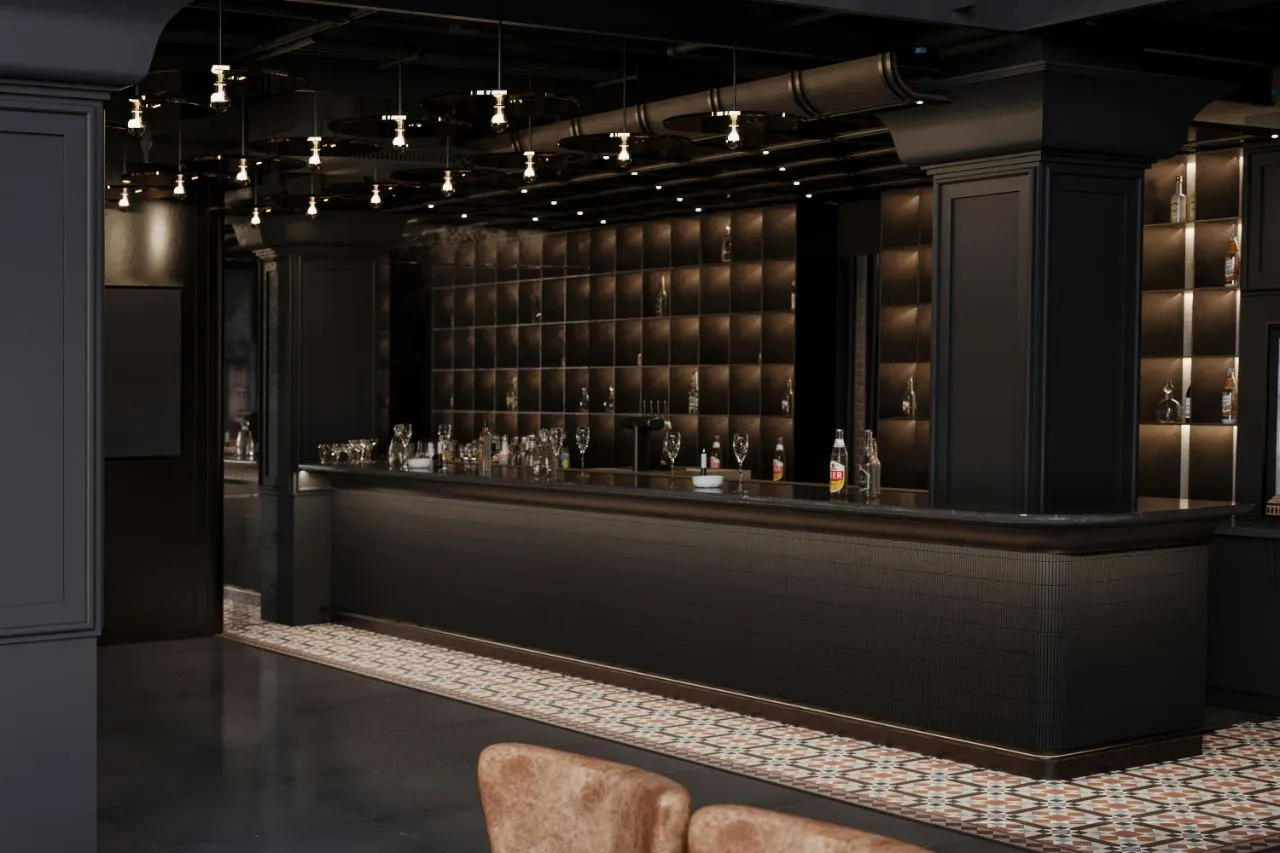 Long bronze cocktail bar with antiqued mirror tile backbar, disc pendant lighting and cement tile runner