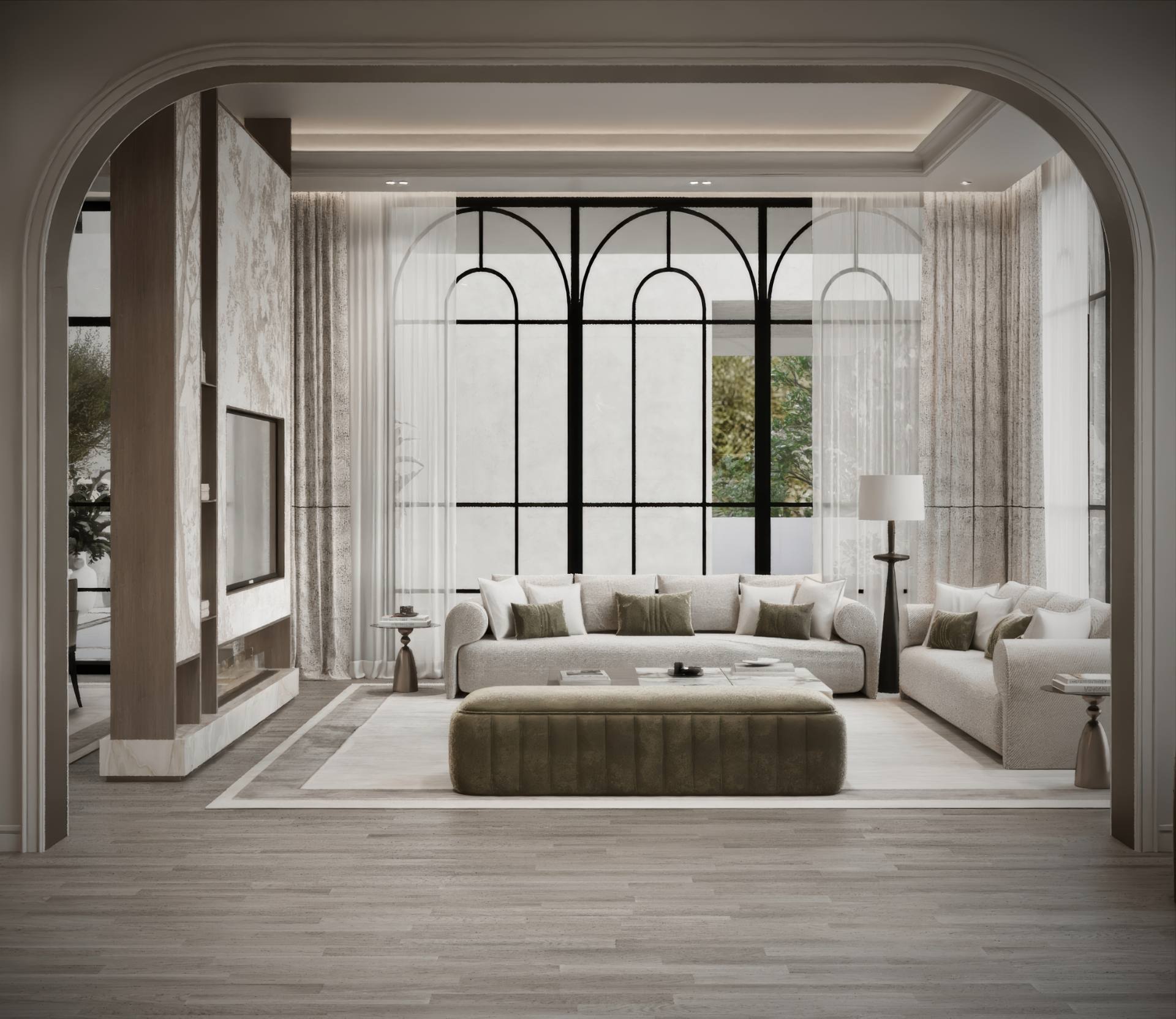 Formal living room seen through a plaster arch, with arched steel window, bouclé sofas and olive velvet ottoman