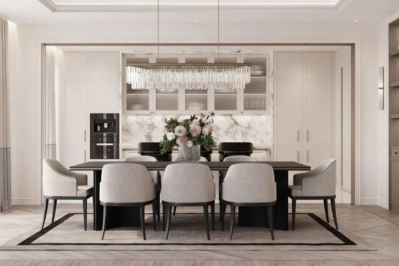 Formal dining room with a black stone table, eight cream chairs, calacatta splashback and a linear crystal chandelier