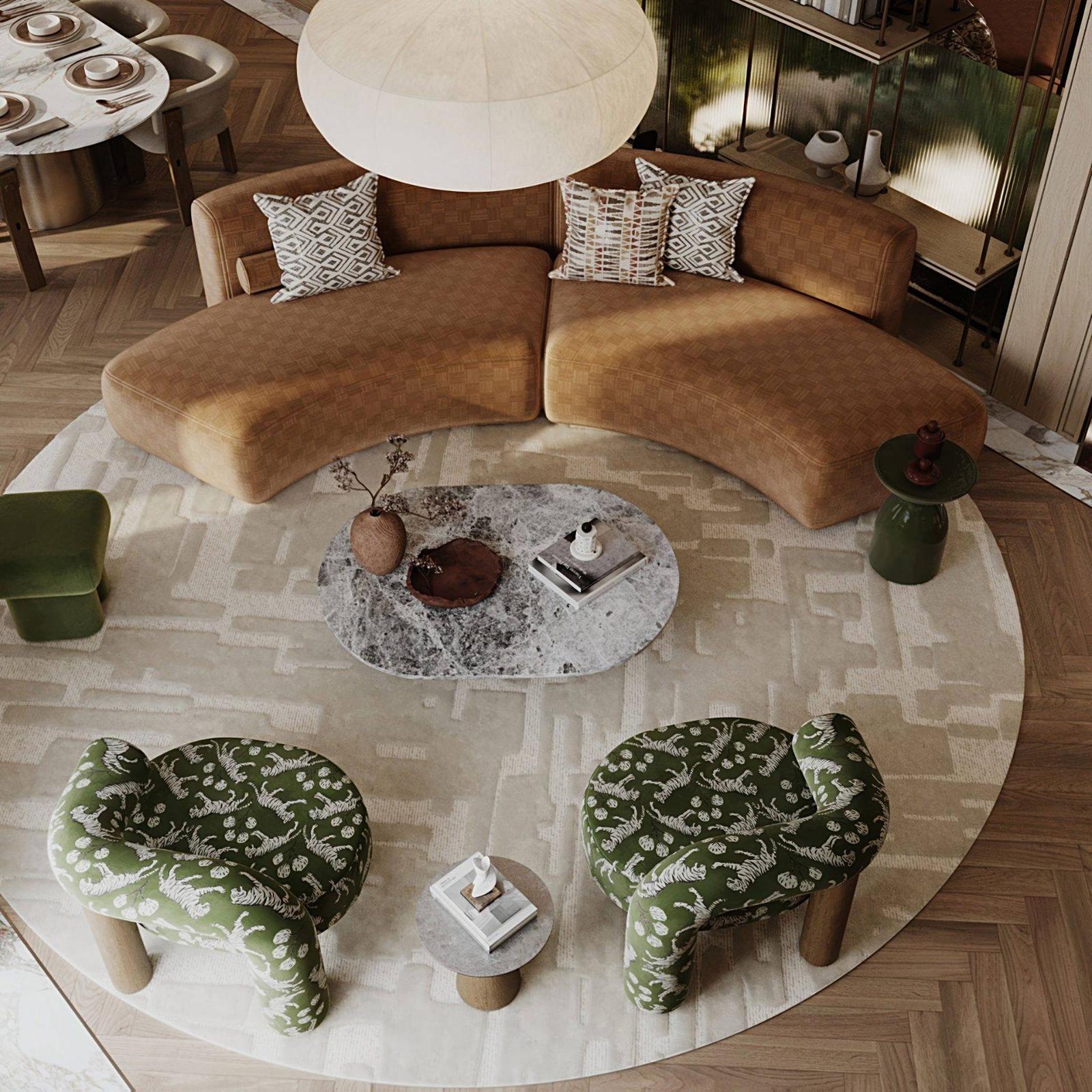 Overhead view of the villa living room with a curved tan sofa, printed olive armchairs and a round rug on herringbone oak
