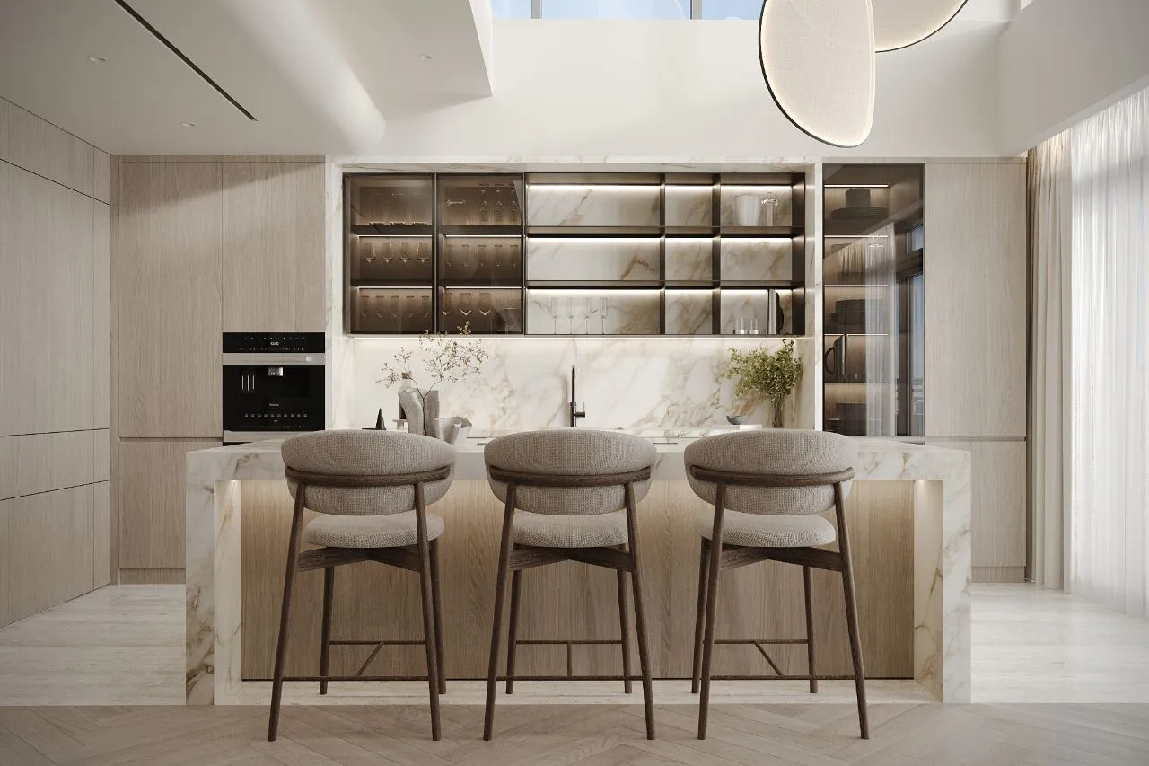 Kitchen with a gold-veined calacatta island and splashback, three upholstered oak stools and lit bronze-glass display cabinets