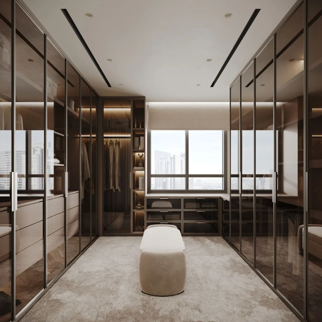 Master dressing room lined with bronze-glass wardrobes, lit interiors, drawer banks under the window and a pale upholstered bench