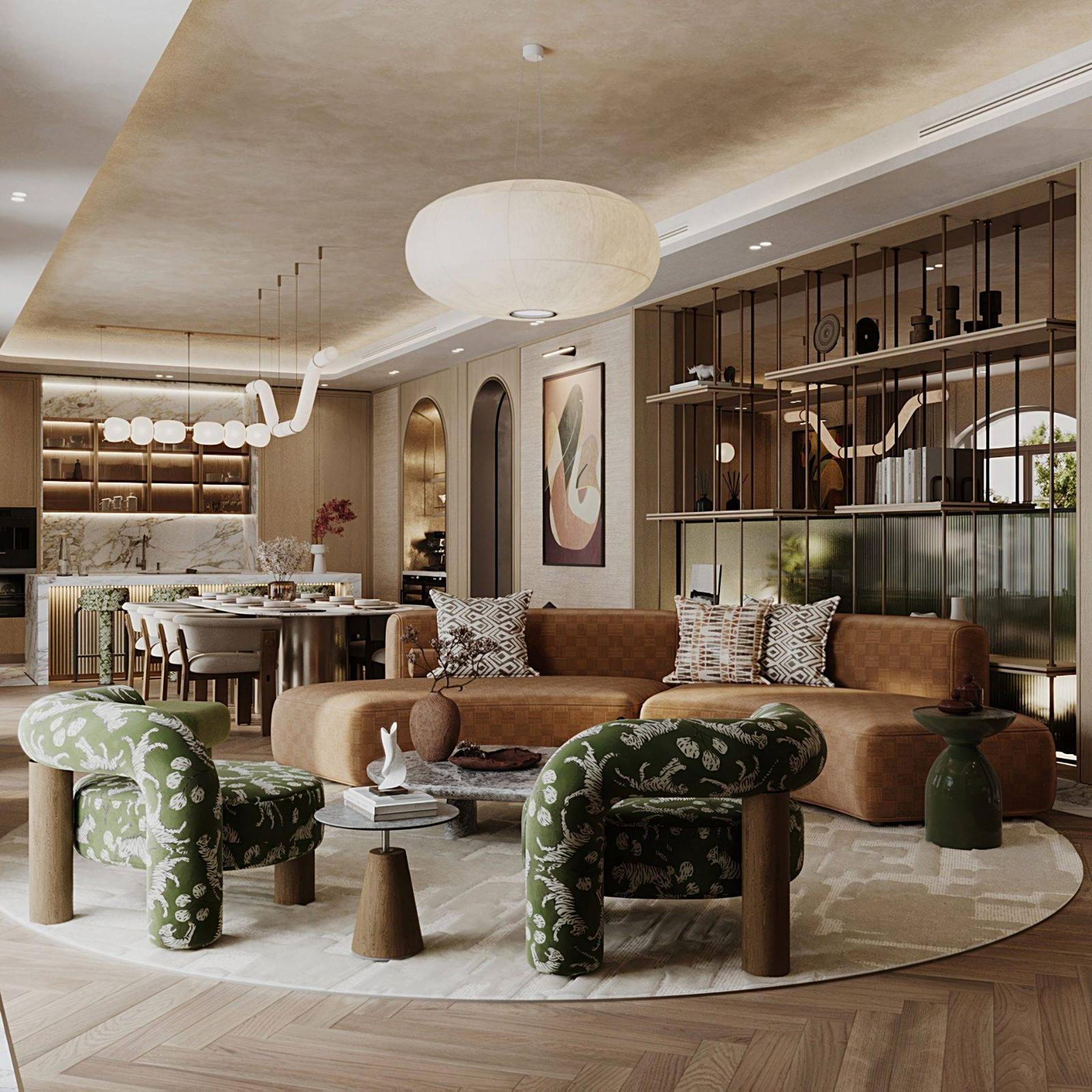 Open-plan living and dining area of a Victory Heights villa in Dubai, with a curved tan sofa, printed green armchairs and a marble kitchen island beyond
