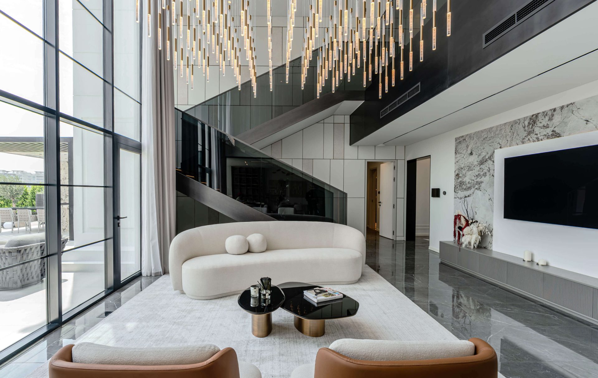 Double-height living room with marble media wall