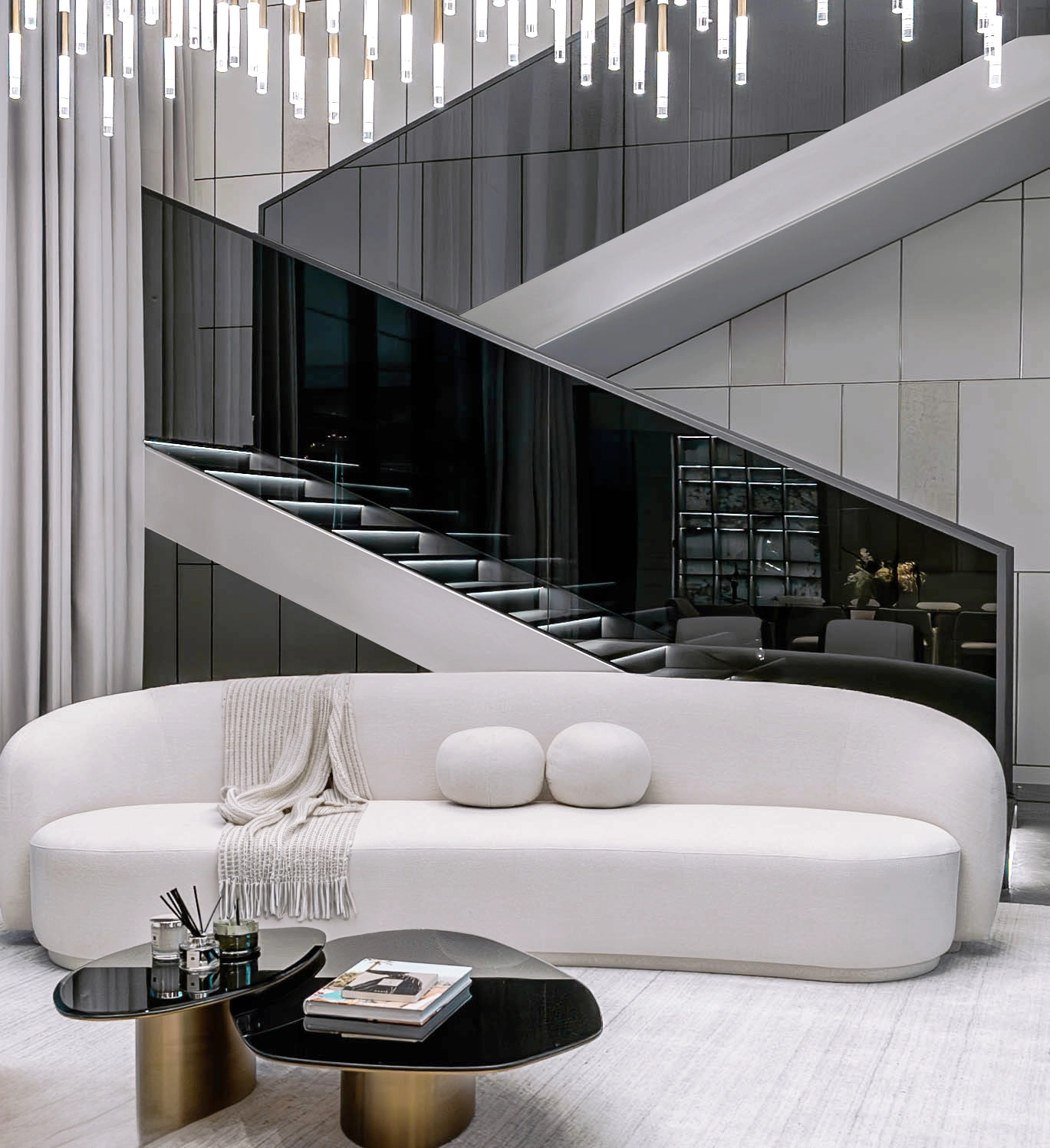 Lounge with curved sofa beneath the mirrored staircase
