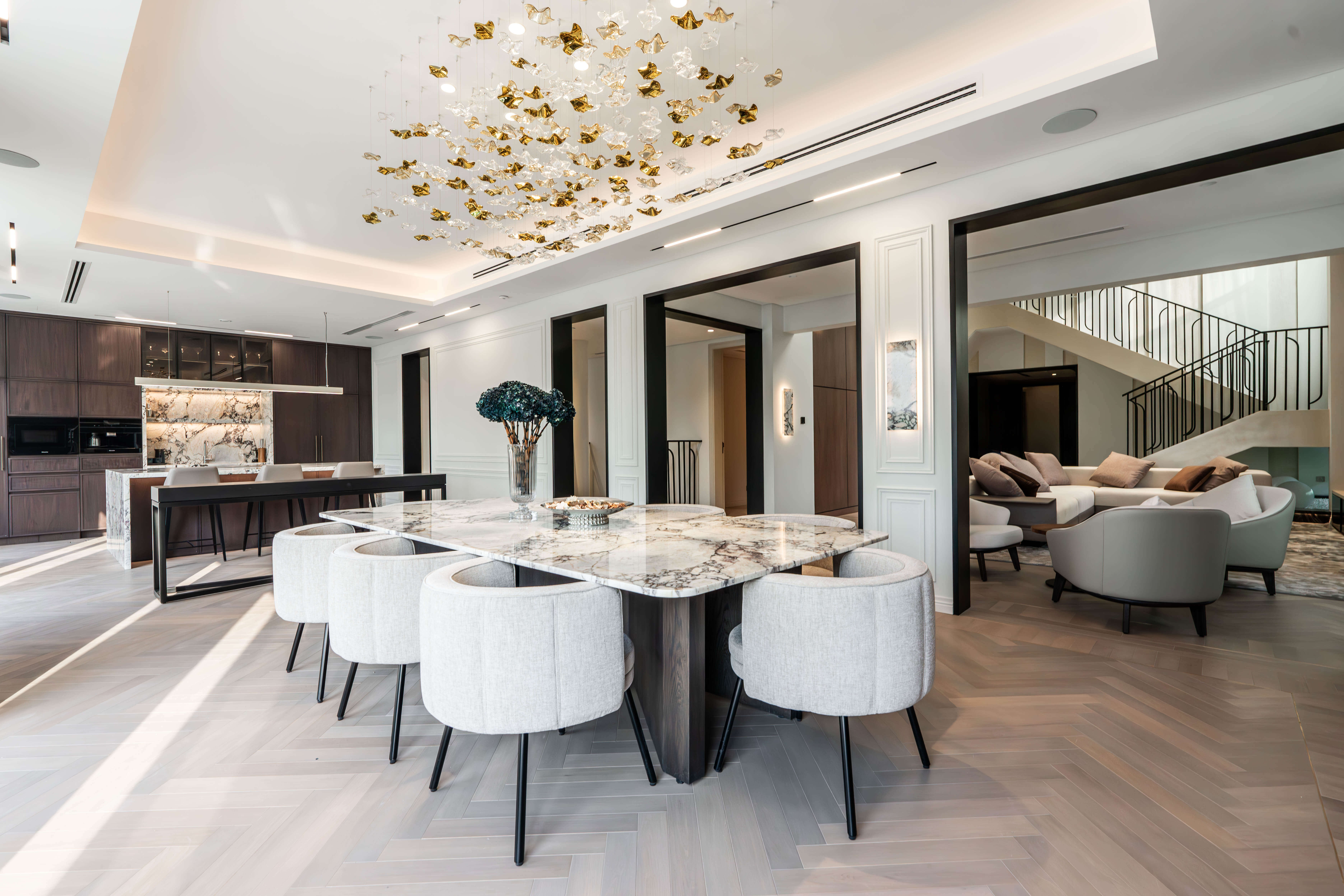 Bespoke marble dining table, joinery and sculptural lighting in a K4 villa