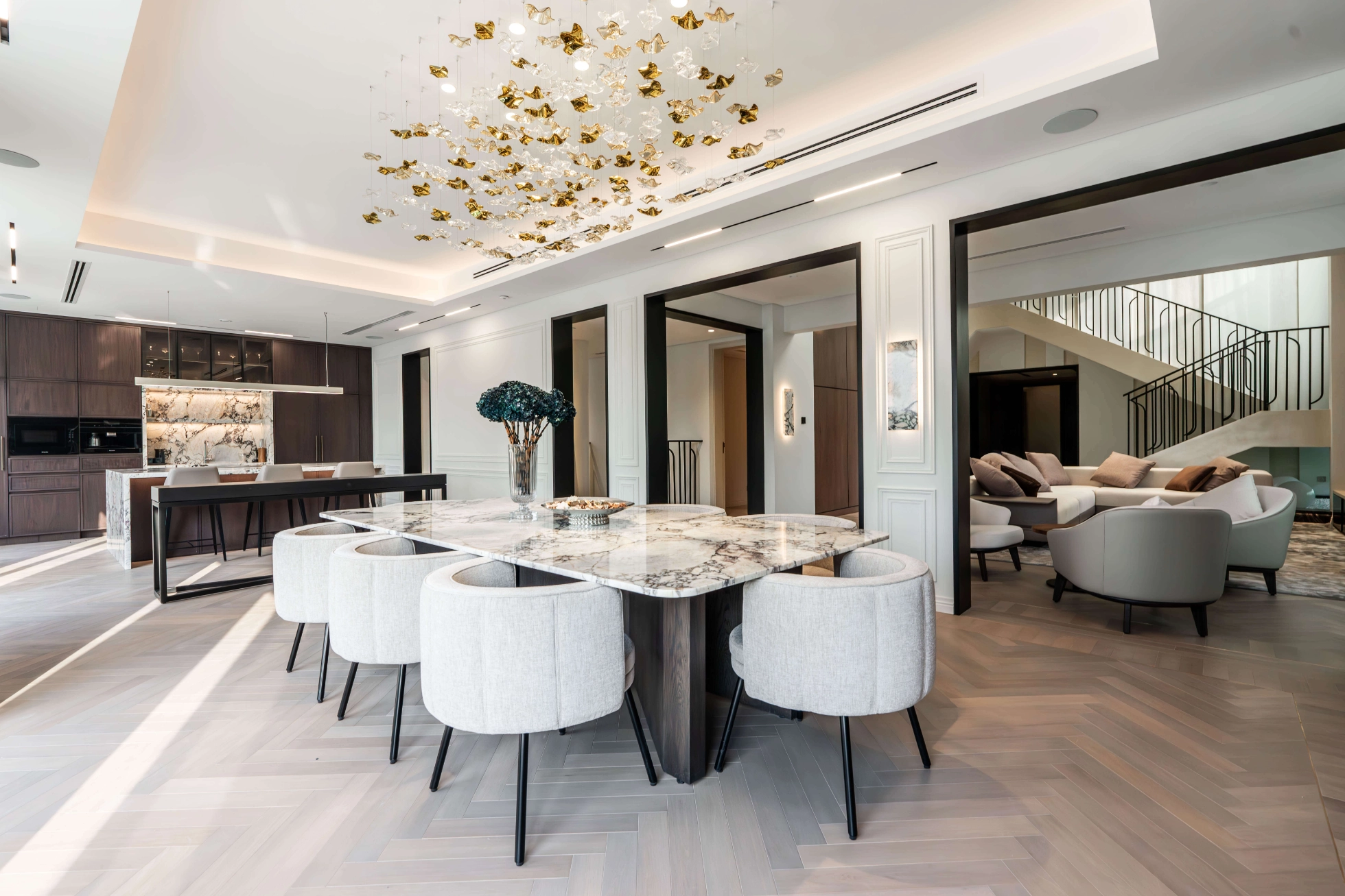 Bespoke marble dining table, joinery and sculptural lighting in a K4 villa