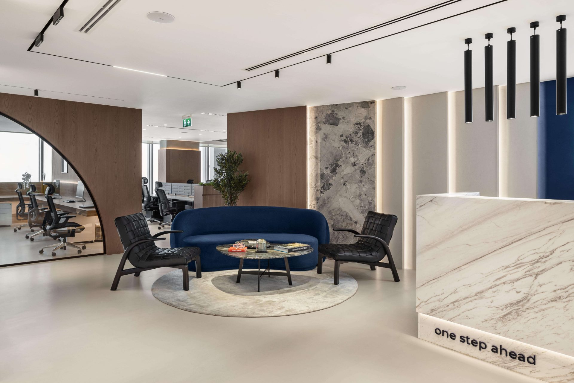 Reception lounge with blue sofa and marble desk