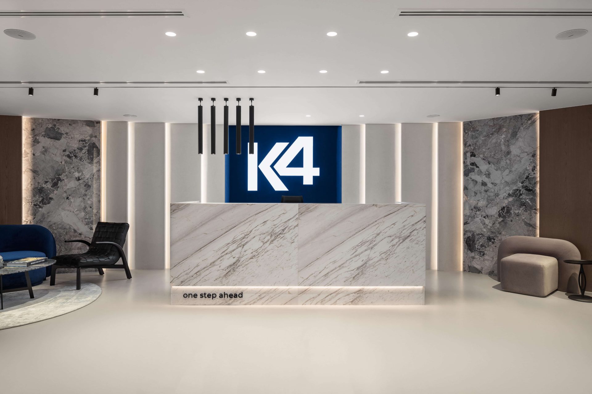 K4 head office reception with illuminated K4 logo and marble desk