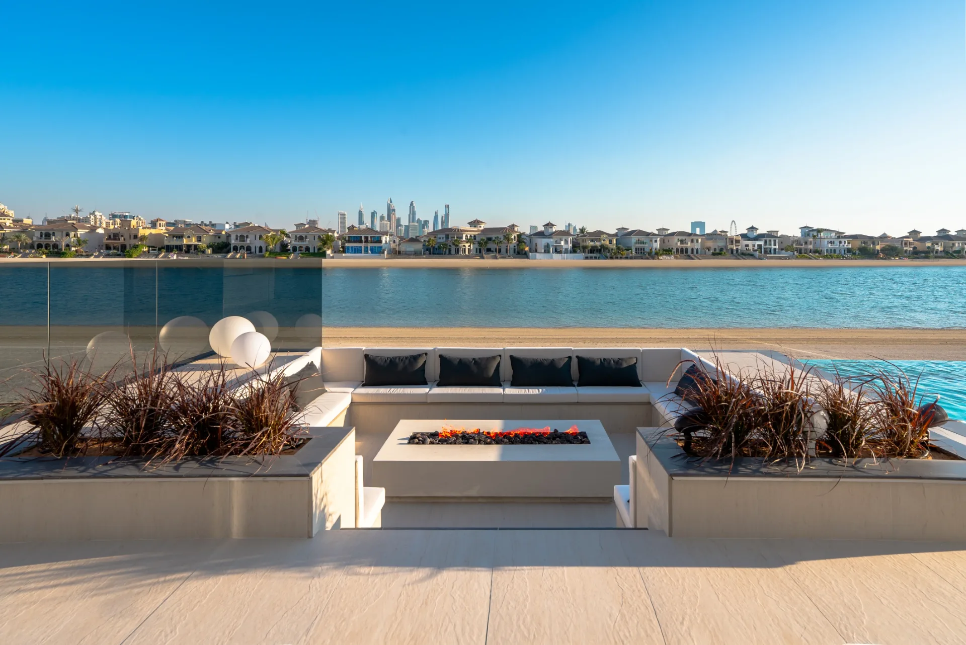 Beachfront fire-pit lounge by day