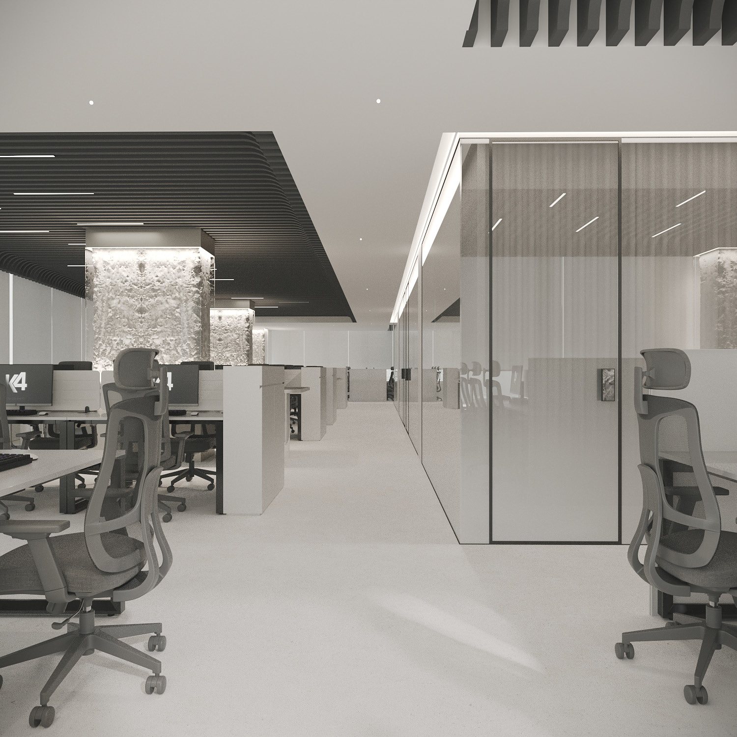 Open-plan workstations beside glass offices and stone-clad columns