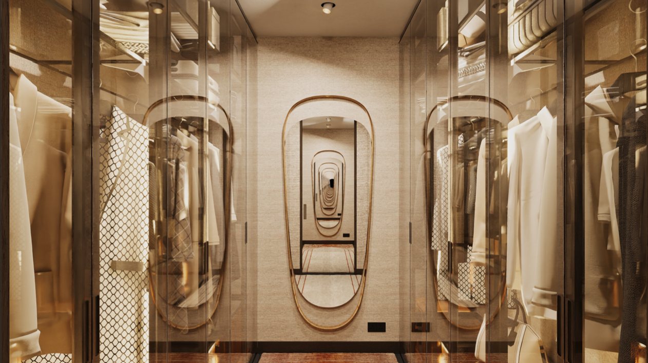 Glass-fronted walk-in wardrobe with brass-framed mirror