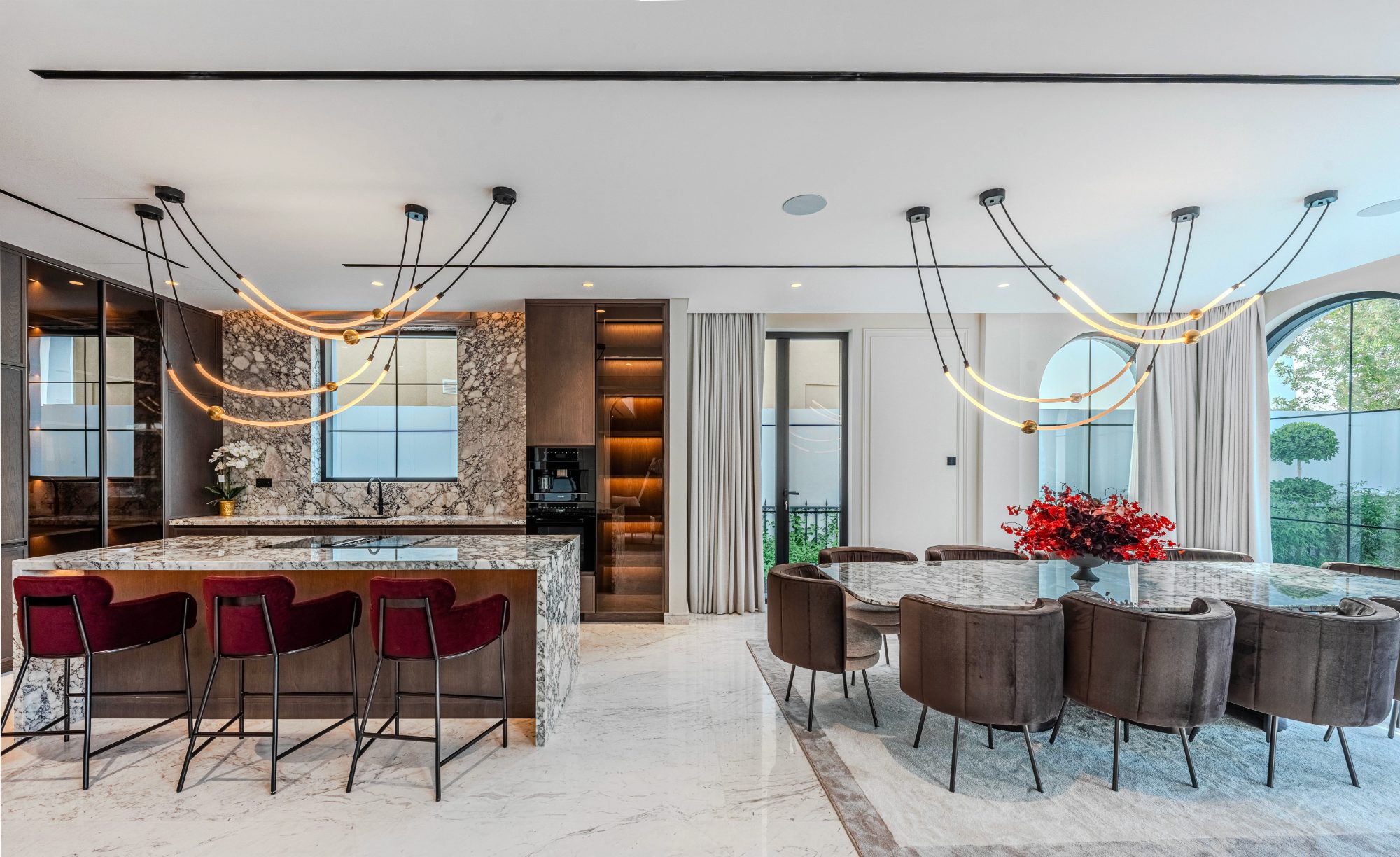 Marble island kitchen with burgundy bar stools