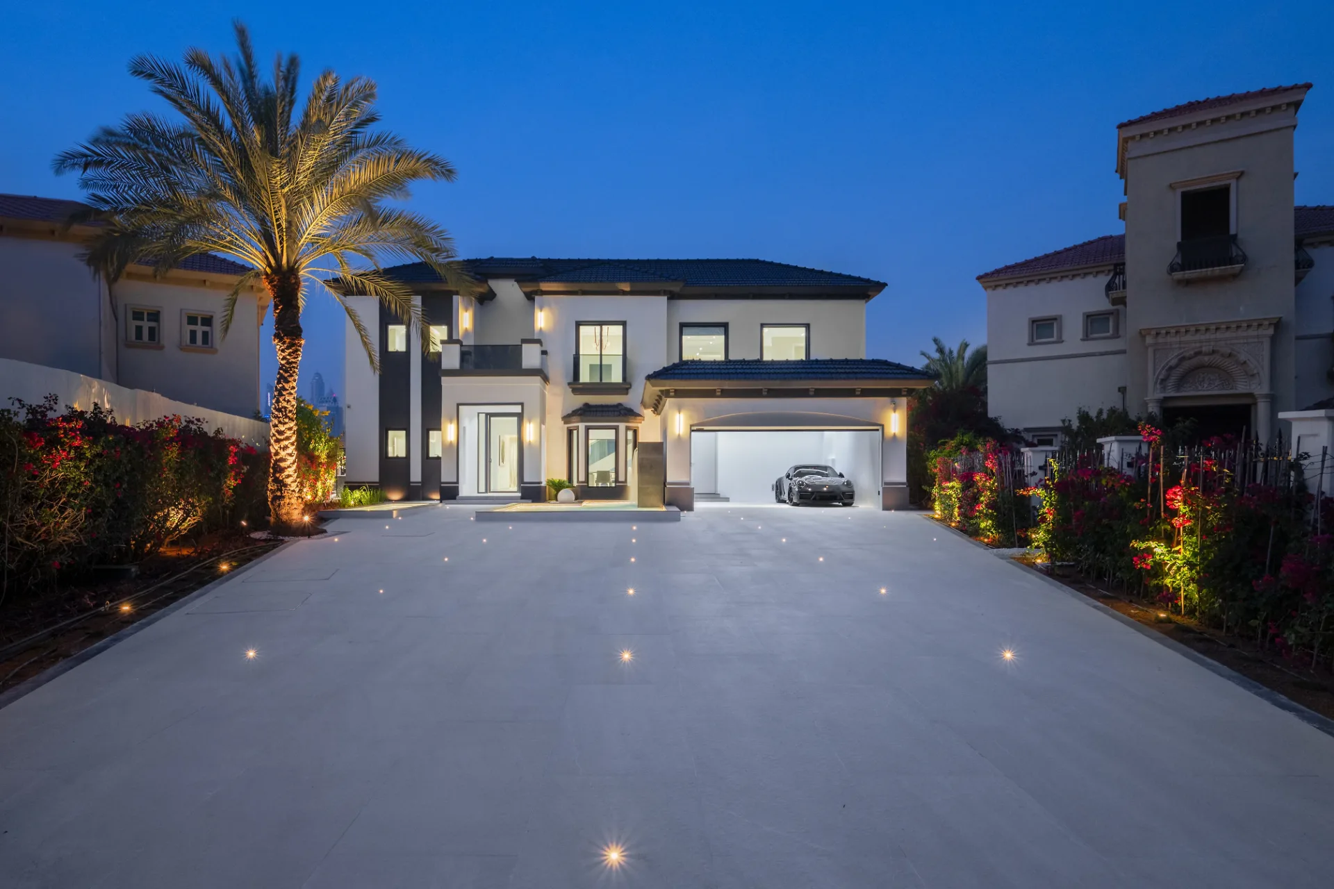 Floodlit arrival court and driveway at night