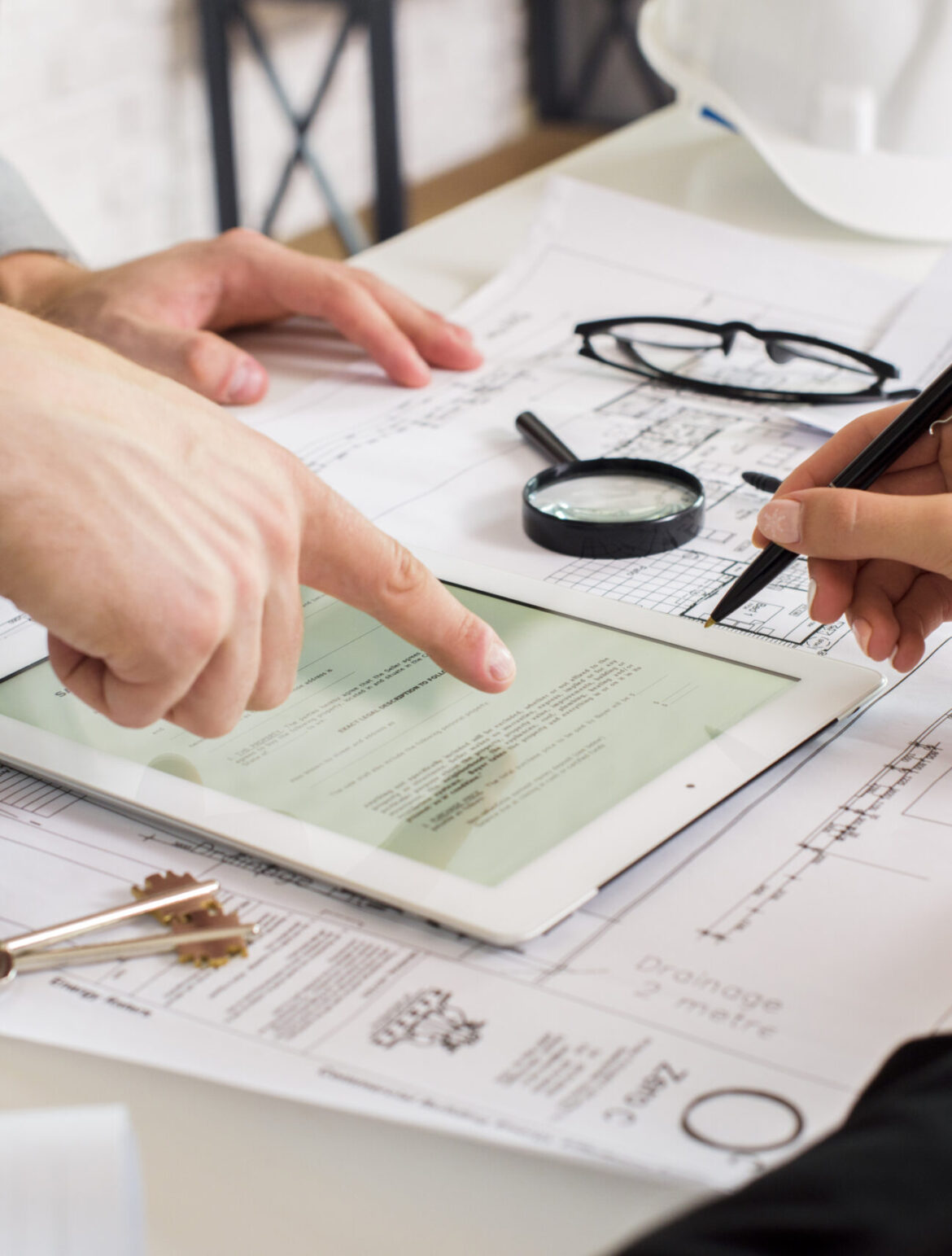 businessmen-analyzing-business-plan-tablet
