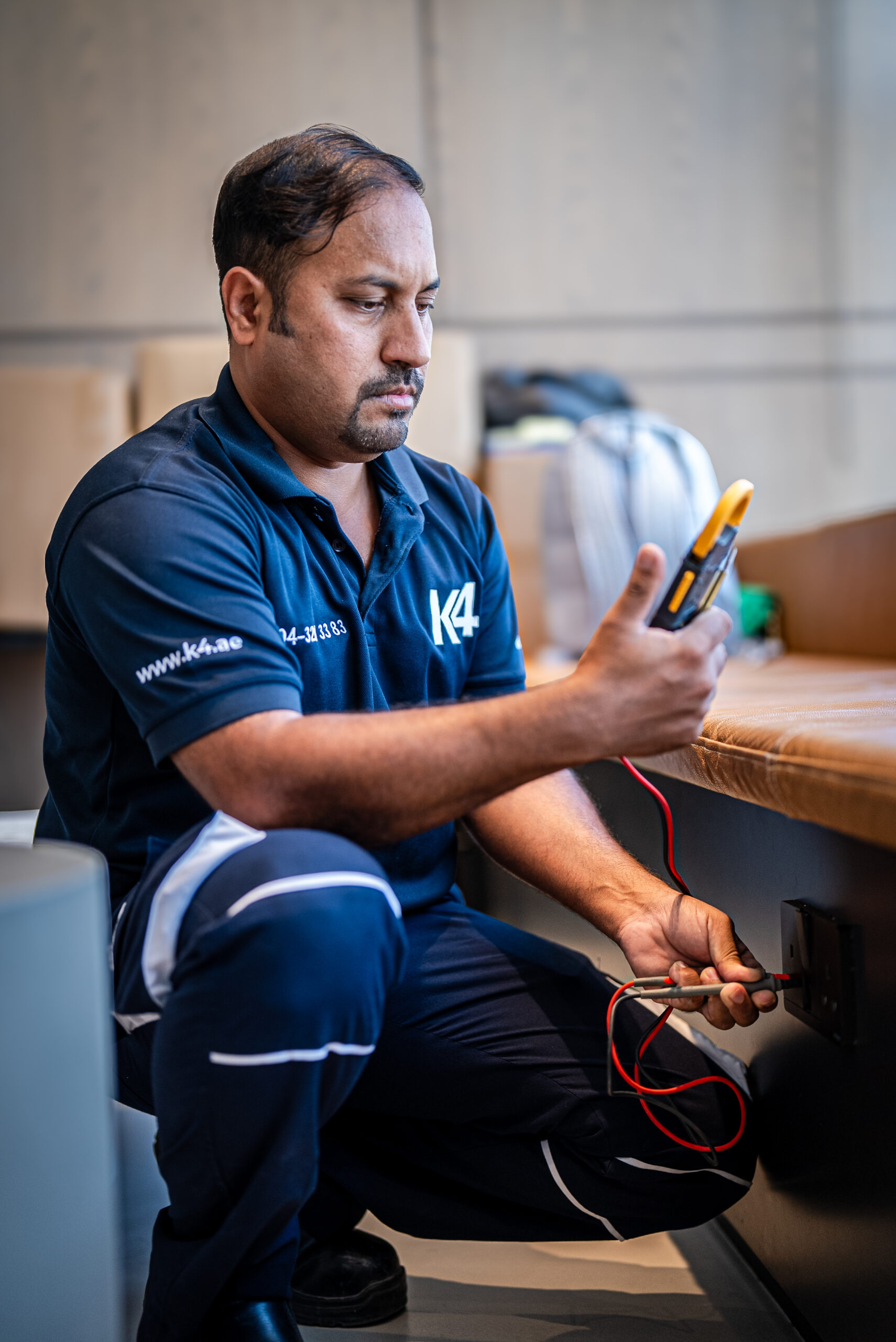 K4 technician testing an electrical socket