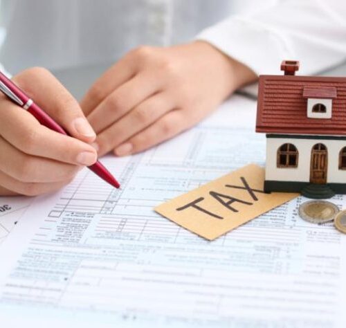 Property tax paperwork with model house