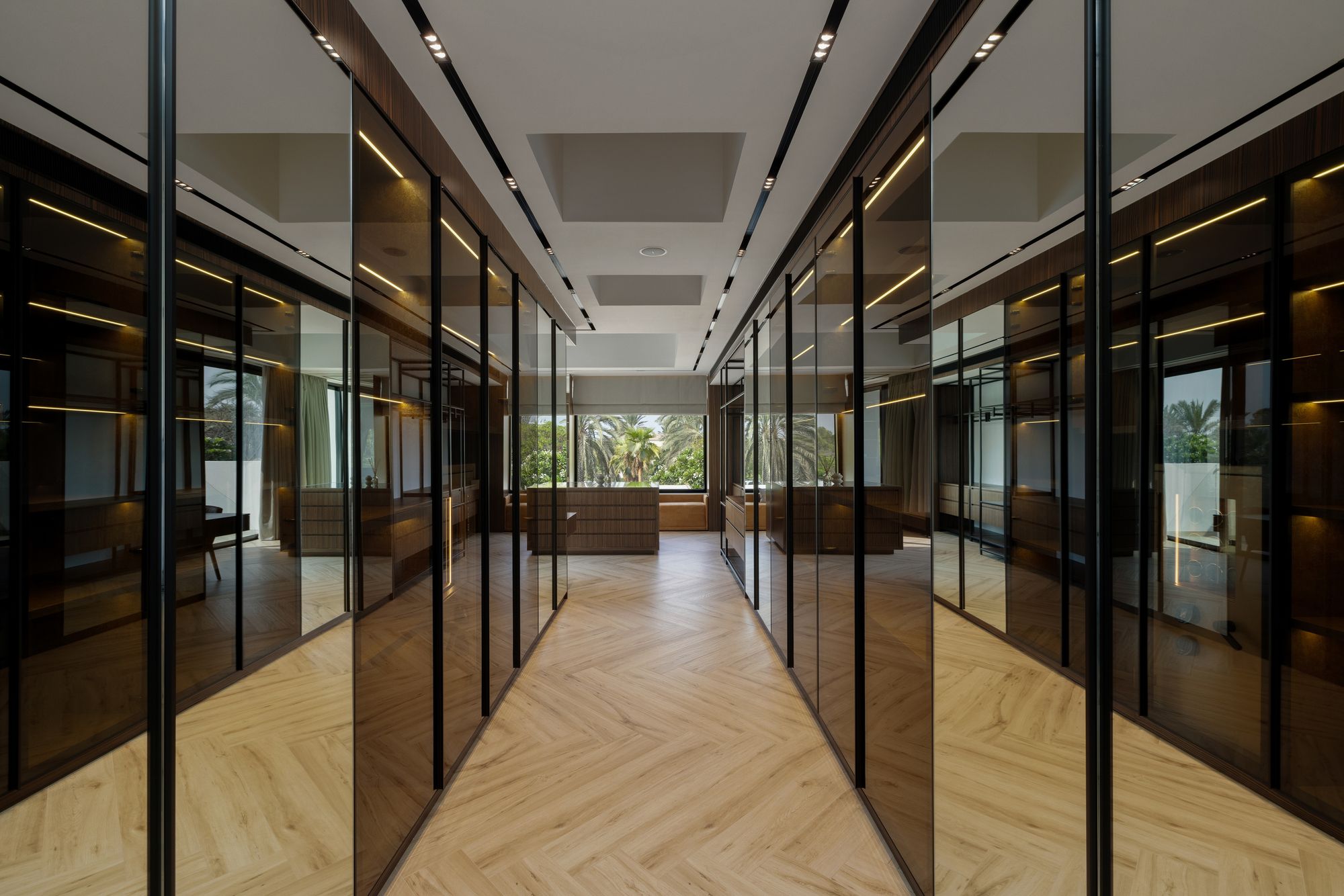Walk-in wardrobe with smoked-glass cabinetry