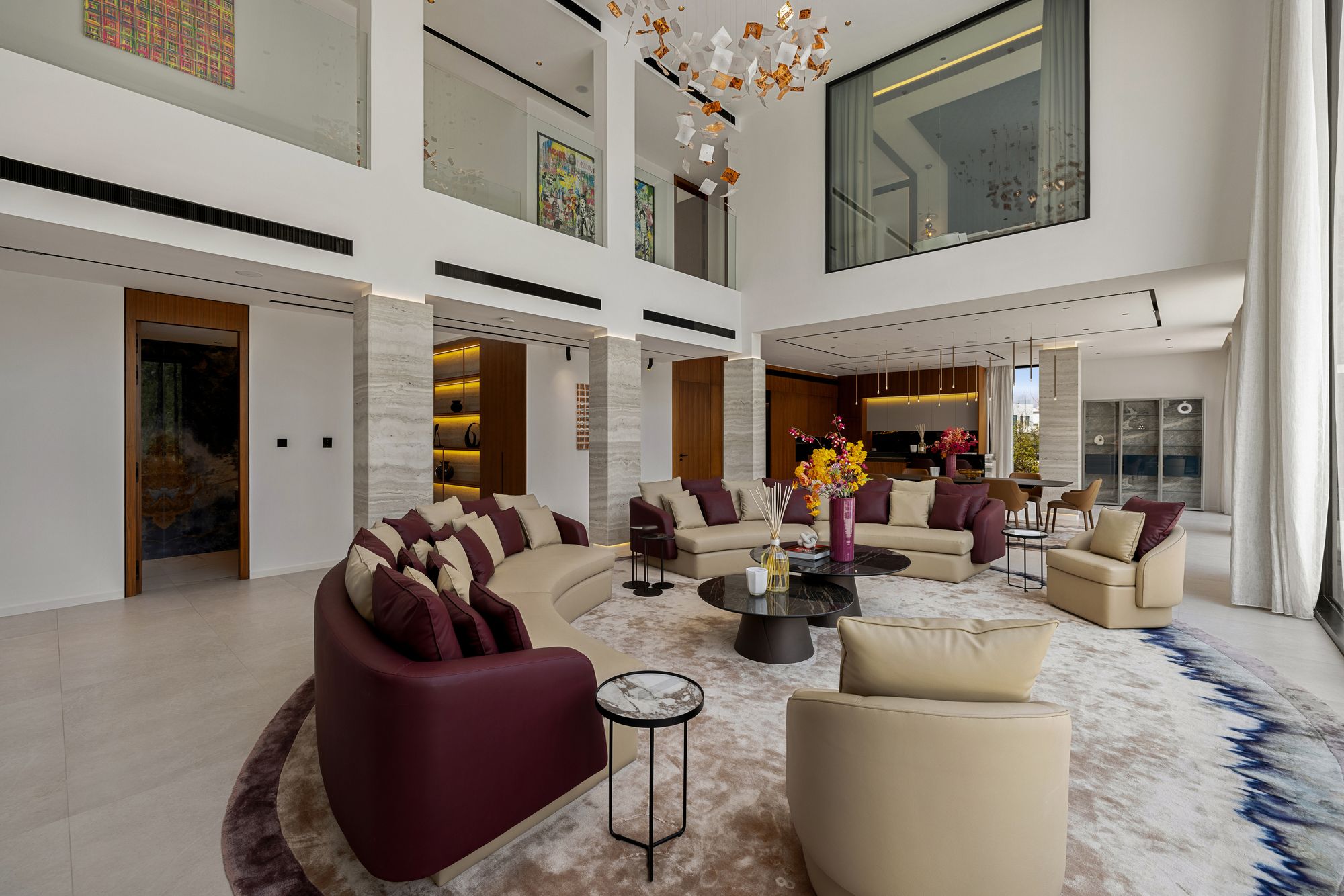 Double-height lounge with designer seating and feature chandelier