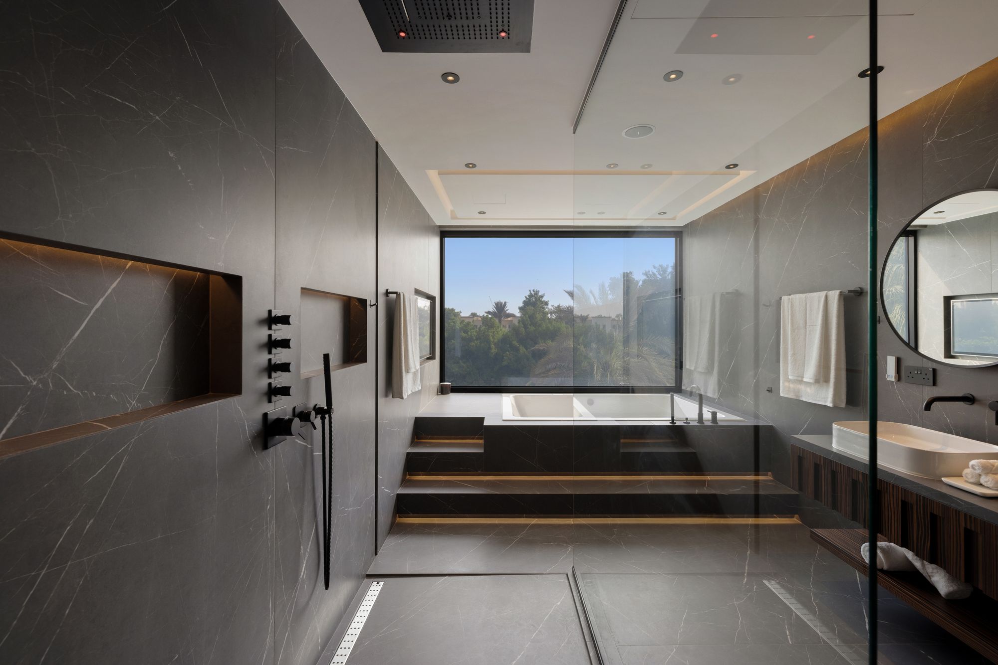Master bathroom with sunken tub and lake-side view